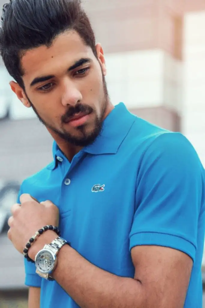 man wearing a blue polo wardrobe essentials shirt