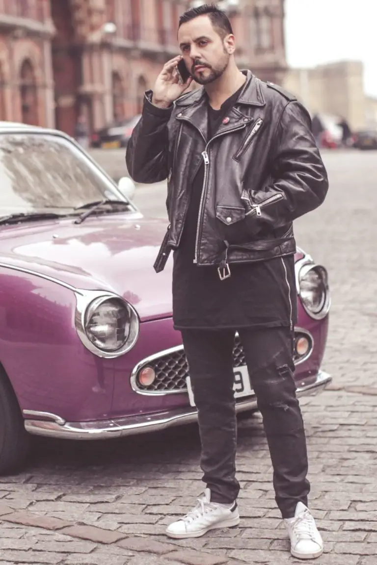 black leather jacket nest to a purple car